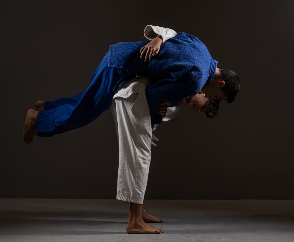 Young ethnic judoists performing nage waza technique